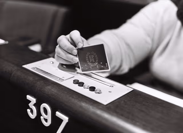 Illustration picture showing a hand holding an electronic vote in the hemicycle of the European Parliament in Strasbourg in October 1979.
