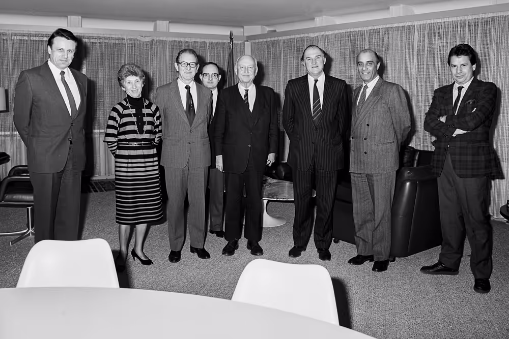 Lord HENRI PLUMB meets with guests in his office