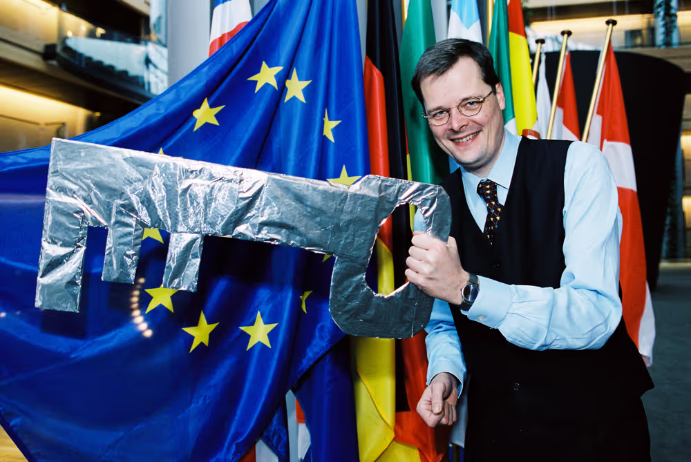 MEP Joachim WUERMELING with a huge key next to a European flag in Strasbourg