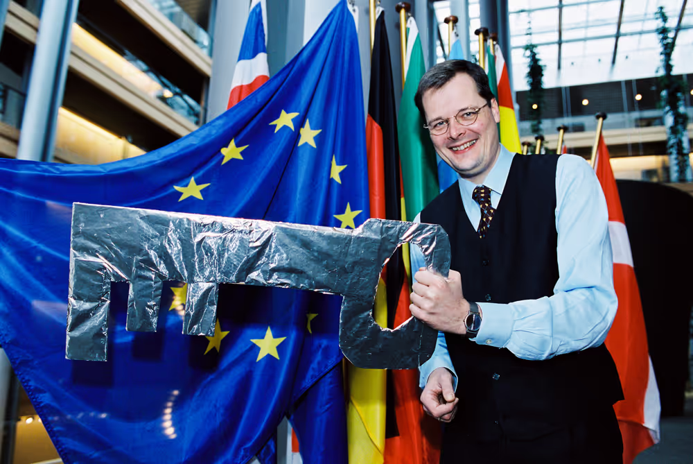 MEP Joachim WUERMELING with a huge key next to a European flag in Strasbourg
