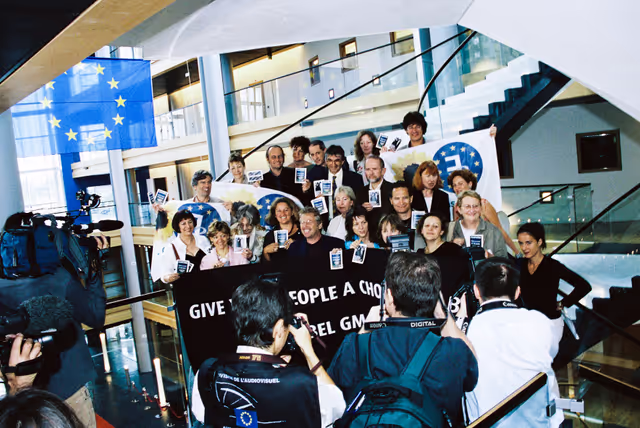 Greens - EFA Meps with a banner that reads ' Give your people a choice, Mr Bush. Label GM food ! '