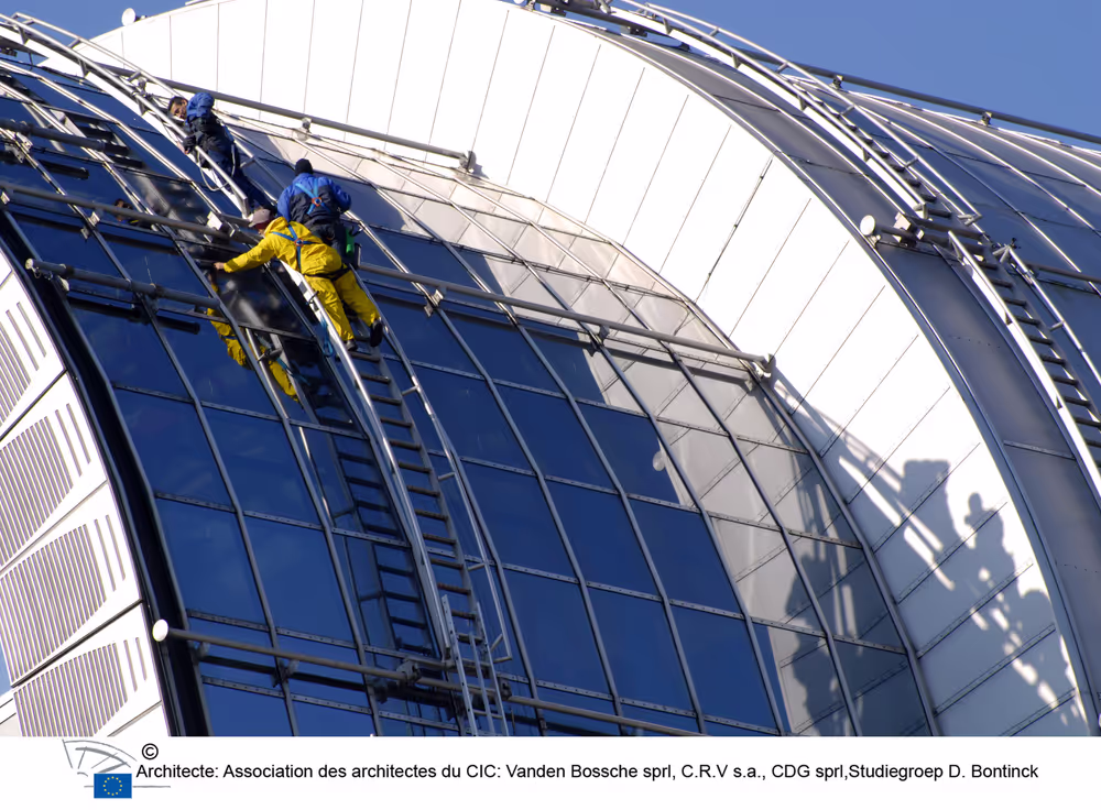 Window cleaners at work on the roof of the EP in Brussels.