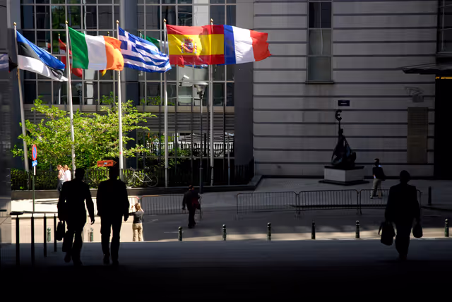 Photo 23: People walking in front of the flags of the EU member states at the EP in Brussels.