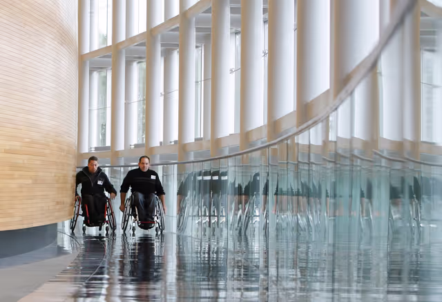 Two handicaped people in a wheelchair visiting the European Parliament in Strasbourg