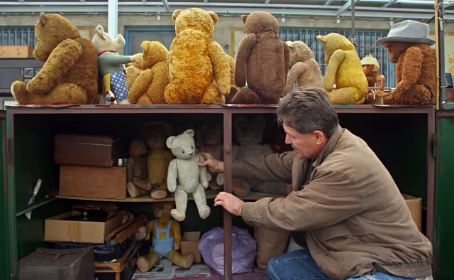 Photo 5: A hungarian saler prepare an old teddy beer for sale in the Budapest oldest junk and antiques market Ecseri