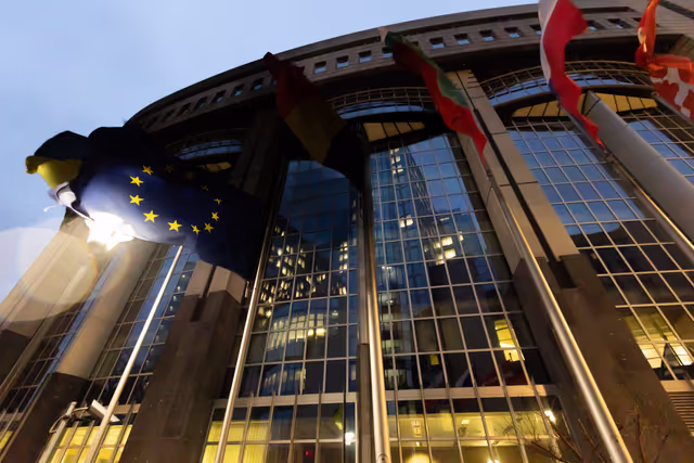 European flags at half-mast in front of the European Parliament building in Brussels and Strasbourg in honour of former European Commission President Jacques Delors
