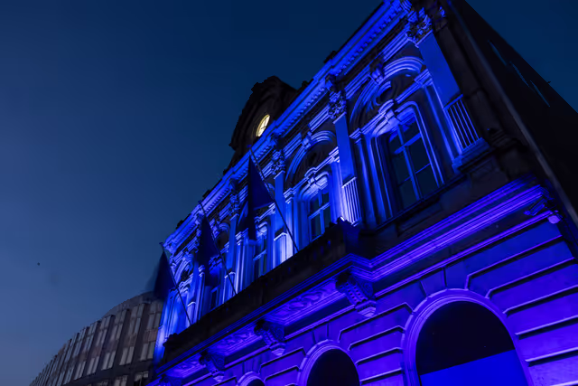 International Missing Children's Day 2026 - Station Europe building illuminated in blue