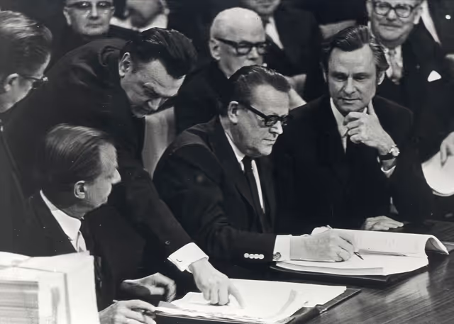 Danish Minister for Foreign Economic Relations Ivar Norgaard, Prime Minister Jens Otto Krag and Secretary for Economic Affairs Jens Otto Christensen sign for Denmark the adhesion Treaty in Brussels